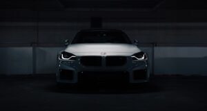 A white car parked in a parking garage